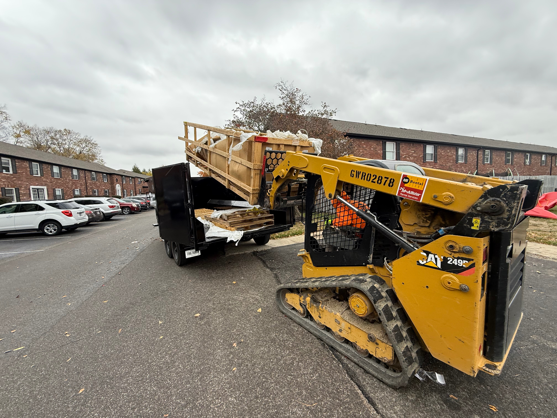 Gone Today Hauling skid steer loading a dump trailer on a Central Indiana job site