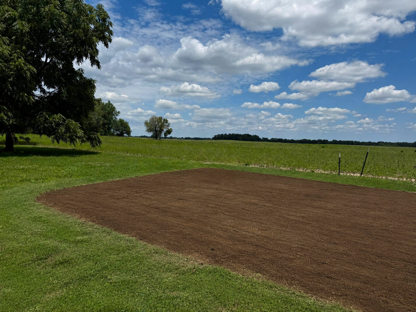 After demolition — clean graded pad where a barn once stood